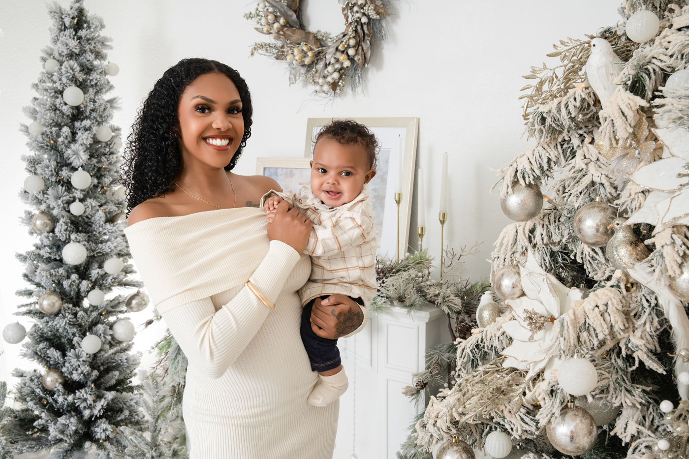 Mother and baby posing in Veronika Gant Photography’s frosted white and gold Christmas studio setup in San Antonio, Texas, showcasing elegant outfit inspiration for Christmas Mini Sessions 2025.